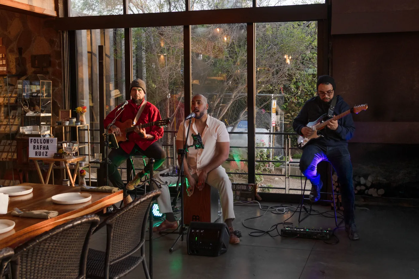 Trío tocando junto al ventanal, con el Valle de fondo